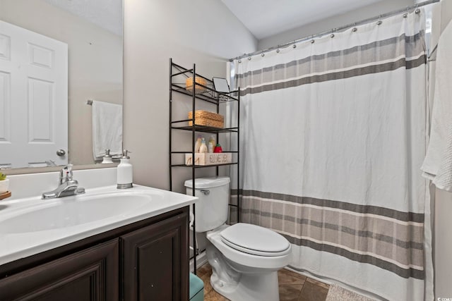 bathroom featuring toilet, a shower with curtain, and vanity