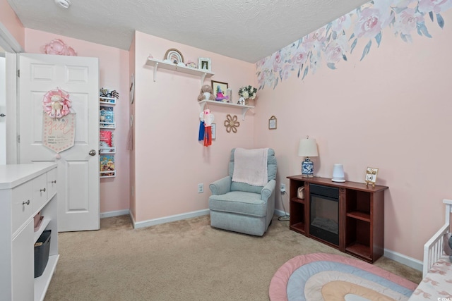 bedroom featuring light colored carpet, a textured ceiling, and baseboards