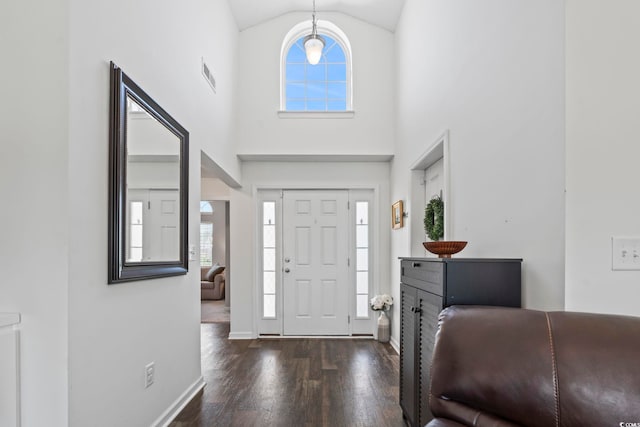 entryway with baseboards, visible vents, a healthy amount of sunlight, and wood finished floors
