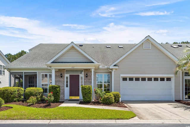 townhome / multi-family property with a garage, roof with shingles, and driveway