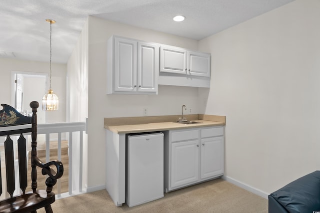 bar featuring fridge, baseboards, light colored carpet, a sink, and wet bar