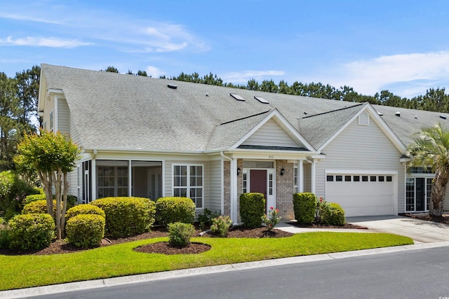 view of front facade with an attached garage, roof with shingles, and driveway