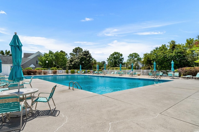 pool featuring fence and a patio