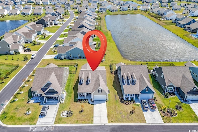 drone / aerial view with a water view and a residential view