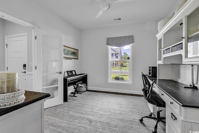 office featuring baseboards, ceiling fan, and visible vents