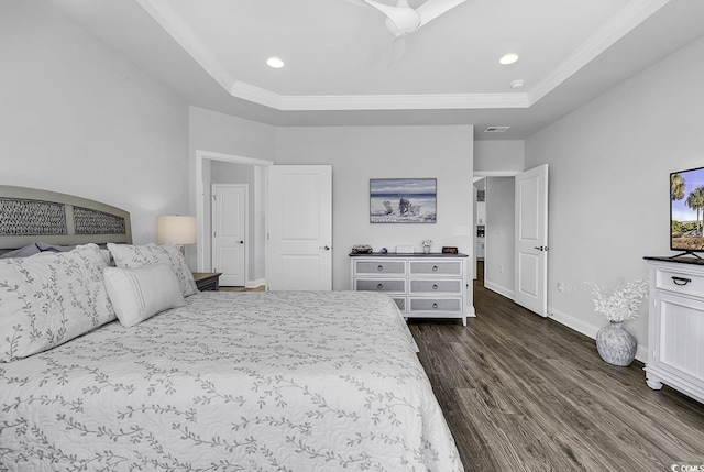 bedroom with baseboards, ornamental molding, a tray ceiling, and dark wood-style floors