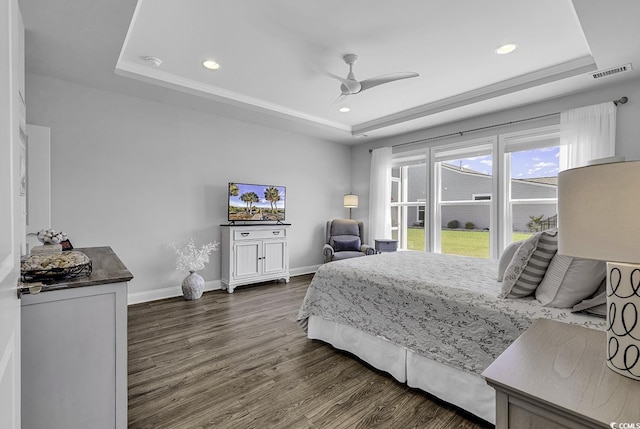 bedroom with a raised ceiling, dark wood-type flooring, recessed lighting, and visible vents