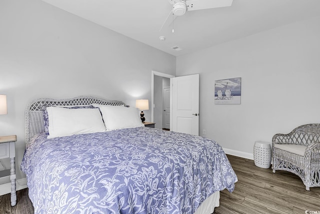 bedroom with a ceiling fan, baseboards, and wood finished floors