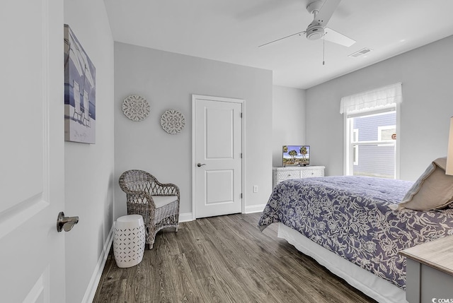 bedroom with ceiling fan, baseboards, visible vents, and wood finished floors