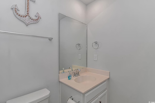 half bath featuring toilet and vanity