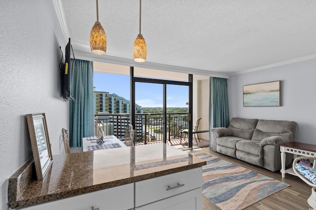 6900 N Ocean Blvd Unit 1105, Myrtle Beach, SC 29572 - living area featuring a textured ceiling, crown molding, wood finished floors, and a wall of windows