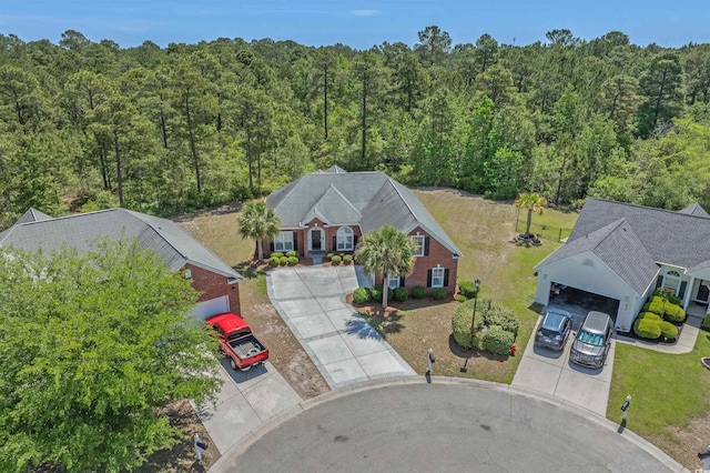 drone / aerial view featuring a forest view