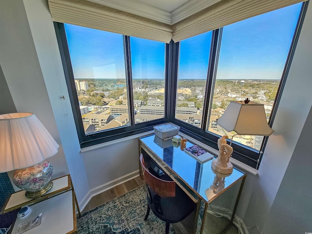 office featuring ornamental molding, wood finished floors, and baseboards