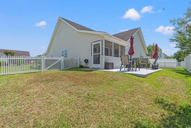 5107 Capulet Cir, Myrtle Beach, SC 29588 - rear view of house with a patio, a sunroom, central air condition unit, a fenced backyard, and a yard