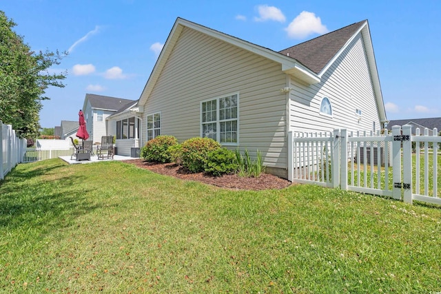 5107 Capulet Cir, Myrtle Beach, SC 29588 - view of property exterior with a shingled roof, a patio, a lawn, and a fenced backyard