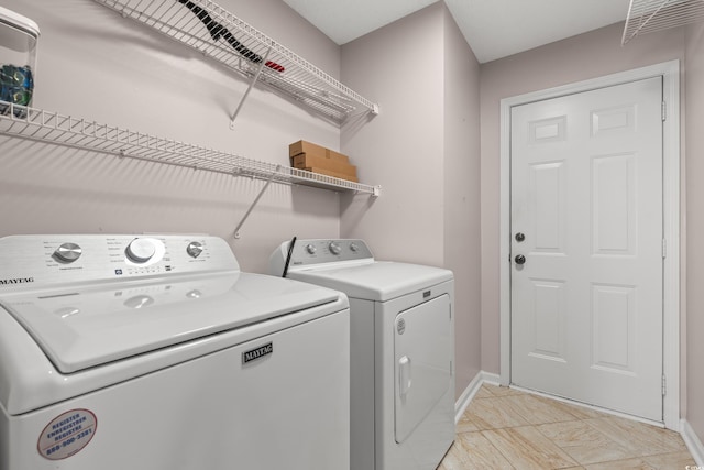 5107 Capulet Cir, Myrtle Beach, SC 29588 - laundry room featuring washing machine and clothes dryer, baseboards, and laundry area