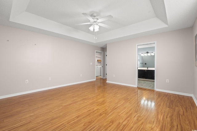 5107 Capulet Cir, Myrtle Beach, SC 29588 - unfurnished room featuring ceiling fan, a raised ceiling, baseboards, and light wood-style floors
