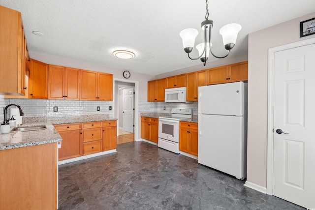 5107 Capulet Cir, Myrtle Beach, SC 29588 - kitchen featuring a notable chandelier, light stone countertops, white appliances, a sink, and backsplash