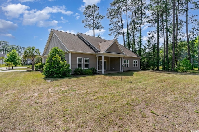 exterior space featuring a yard and roof with shingles