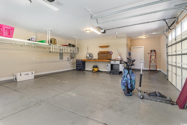garage with baseboards and a garage door opener