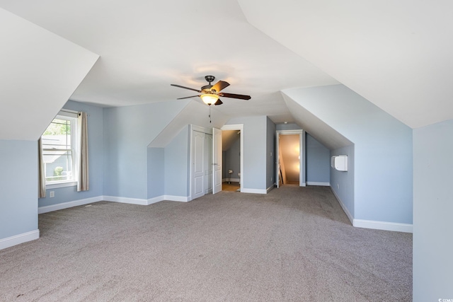 bonus room with carpet flooring, ceiling fan, baseboards, and lofted ceiling