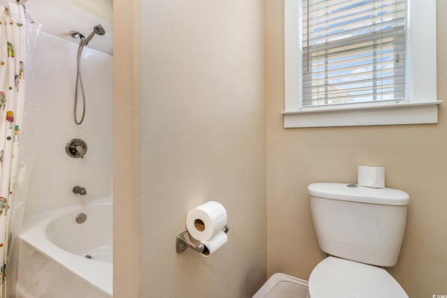 full bathroom featuring toilet and shower / bath combination with curtain