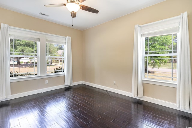 empty room featuring visible vents, baseboards, ceiling fan, and a healthy amount of sunlight