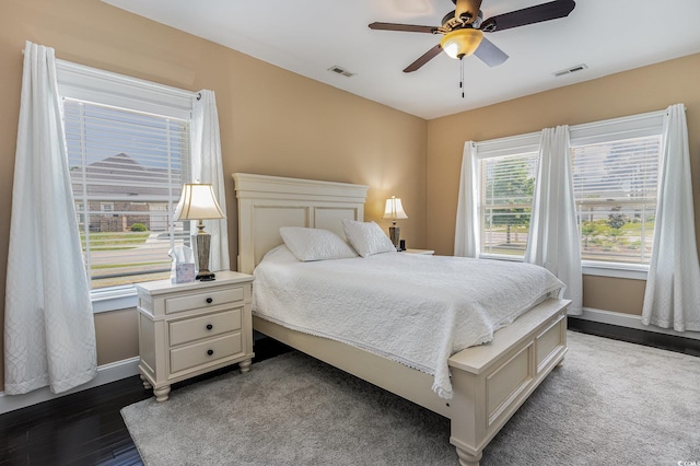 bedroom featuring baseboards, visible vents, and dark wood-style floors