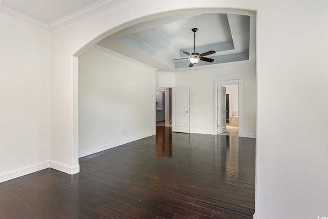 1800 Wood Stork Dr, Conway, SC 29526 - empty room with ceiling fan, a tray ceiling, hardwood / wood-style floors, crown molding, and arched walkways
