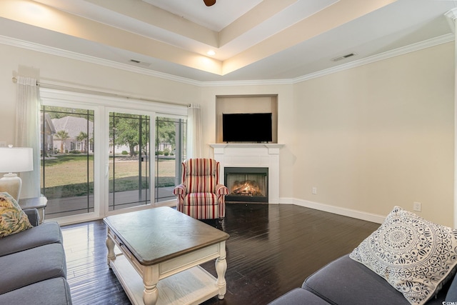 living room featuring visible vents, dark wood finished floors, baseboards, and a warm lit fireplace