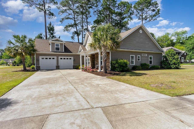 craftsman-style house featuring a garage, concrete driveway, a front lawn, and stone siding