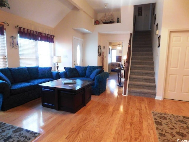 916 Charles St, North Myrtle Beach, SC 29582 - living room featuring light wood-type flooring, high vaulted ceiling, beam ceiling, and stairway