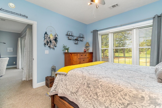 bedroom featuring visible vents, a ceiling fan, carpet, and baseboards