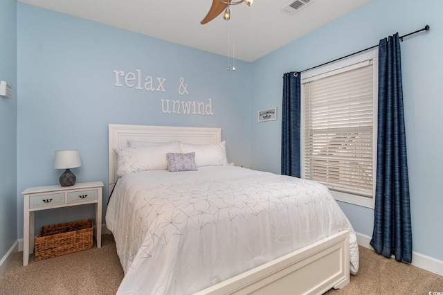 bedroom featuring light colored carpet, baseboards, visible vents, and ceiling fan