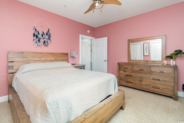 bedroom featuring baseboards, a ceiling fan, and carpet flooring