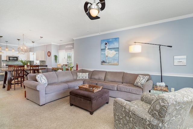 living room with crown molding, a ceiling fan, and light colored carpet