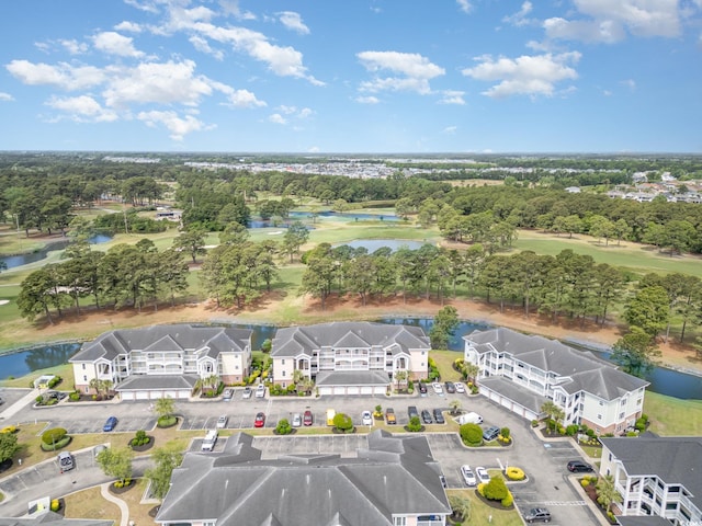 aerial view featuring a water view, view of golf course, and a residential view