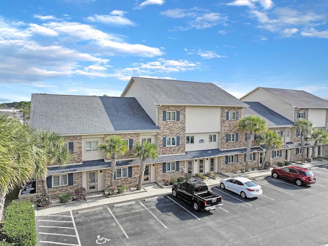 205 Double Eagle Dr Unit C-2, Myrtle Beach, SC 29575 - view of building exterior featuring uncovered parking and a residential view