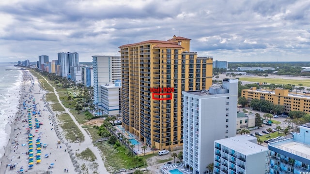 birds eye view of property featuring a view of city, a view of the beach, and a water view