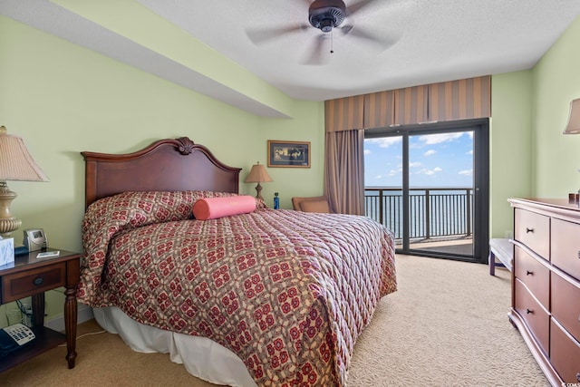 bedroom with carpet flooring, a ceiling fan, and access to exterior