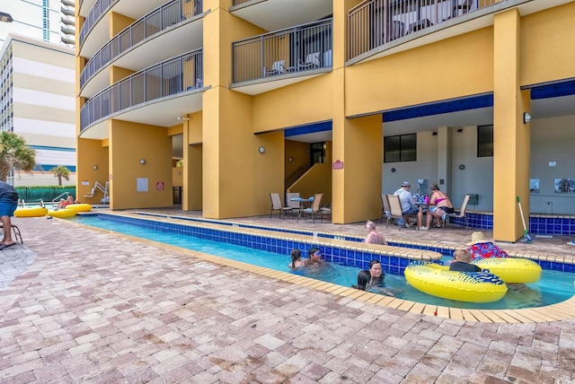 community pool with a patio area