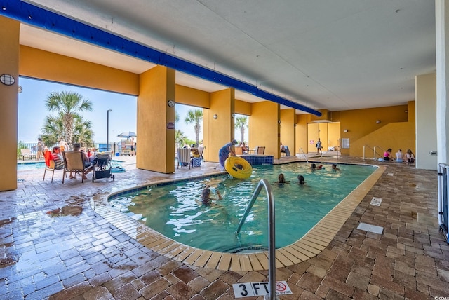 community pool featuring a patio area