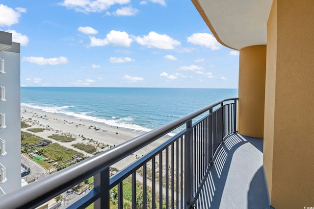 balcony with a beach view and a water view