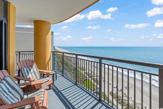 balcony with a water view and a beach view