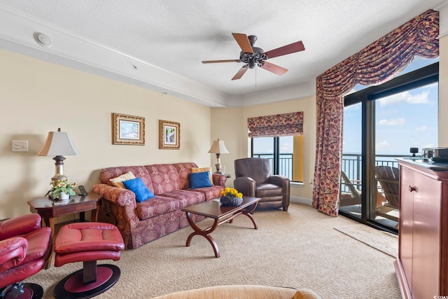 living area with carpet floors and a ceiling fan