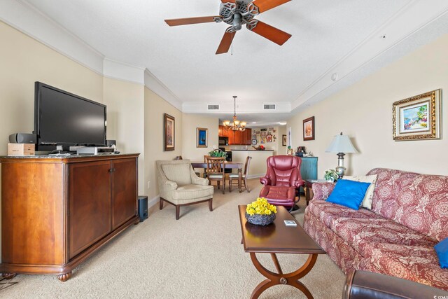 living room featuring visible vents, light carpet, ornamental molding, and ceiling fan with notable chandelier