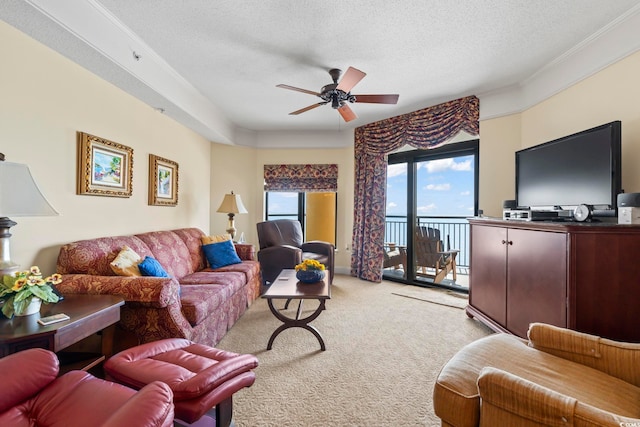 living room with crown molding, light carpet, a ceiling fan, and a textured ceiling