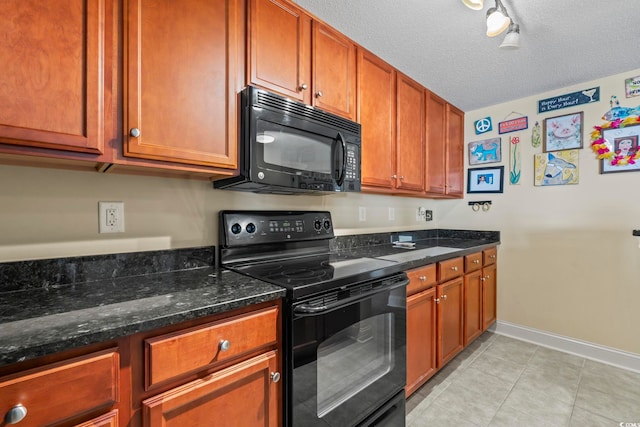 kitchen featuring baseboards, a textured ceiling, dark stone countertops, light tile patterned floors, and black appliances