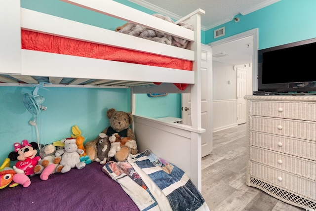 2507 S Ocean Blvd Unit 403, North Myrtle Beach, SC 29582 - bedroom with crown molding, visible vents, and wood finished floors
