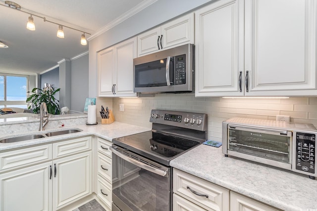 2507 S Ocean Blvd Unit 403, North Myrtle Beach, SC 29582 - kitchen featuring a sink, stainless steel appliances, crown molding, white cabinetry, and decorative backsplash